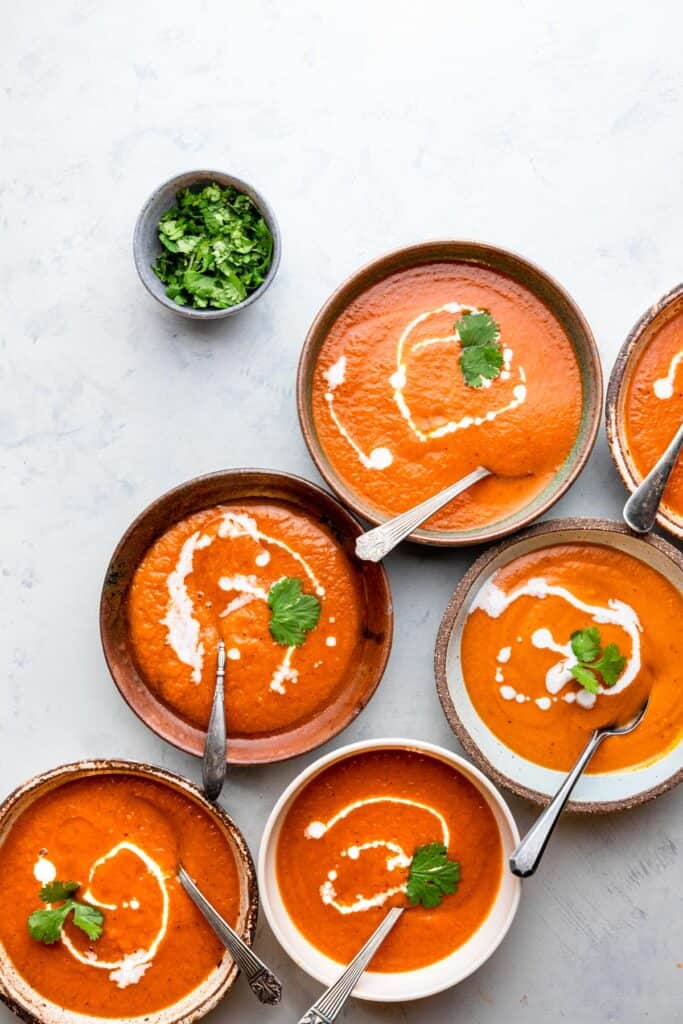 Instant Pot Southwestern Sweet Potato Soup in bowls with cilantro on the side