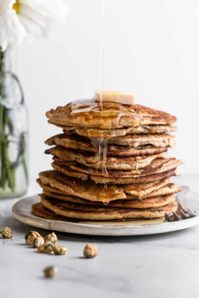 a stack of Keto Coconut Flour Pancakes with butter and syrup on top