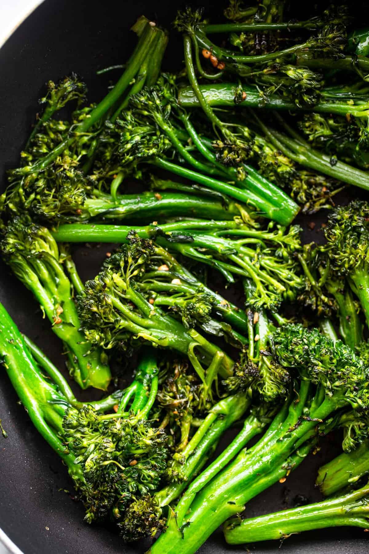 close up of Sautéed broccolini being sauteed