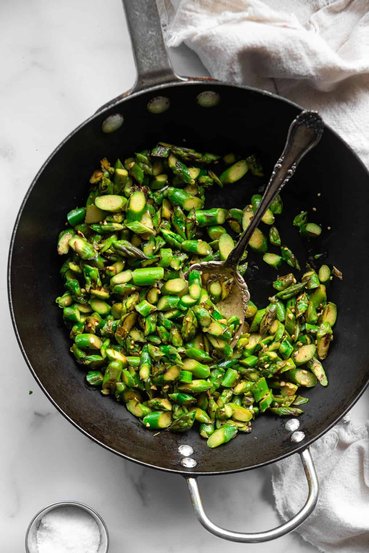 Stir fry asparagus being cooked in a pan