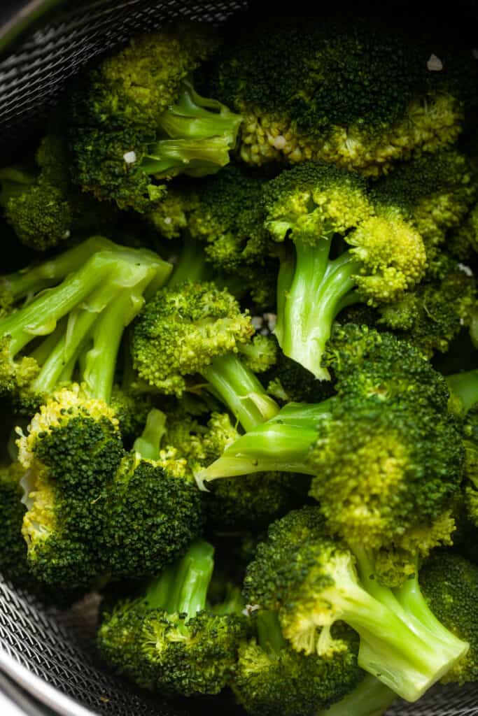 a pile of broccoli in the instant pot for Instant Pot Steamed Broccoli