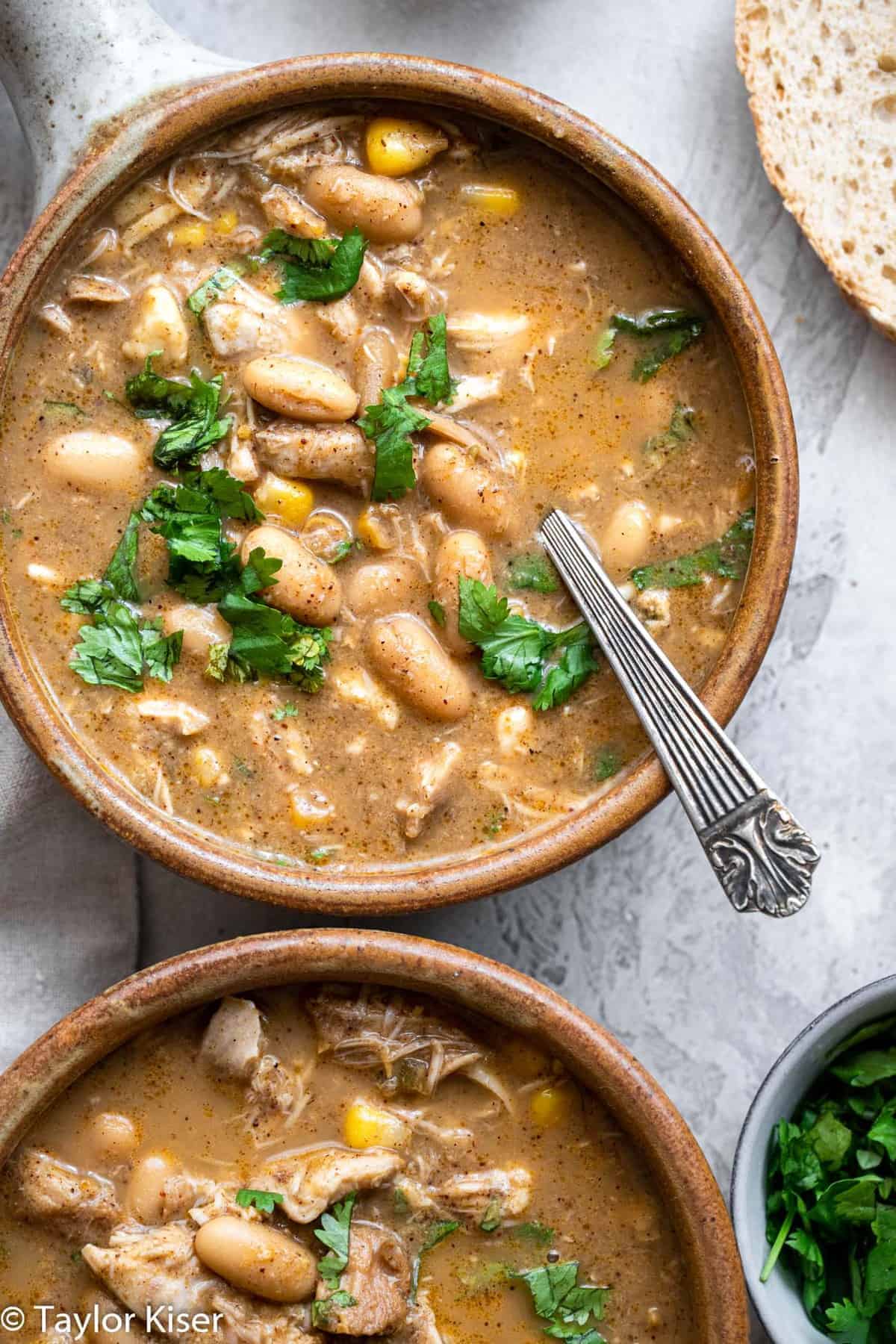 healthy white chicken chili in a bowl with cilantro on top